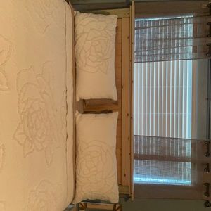 2 white pillow cases with rose detail